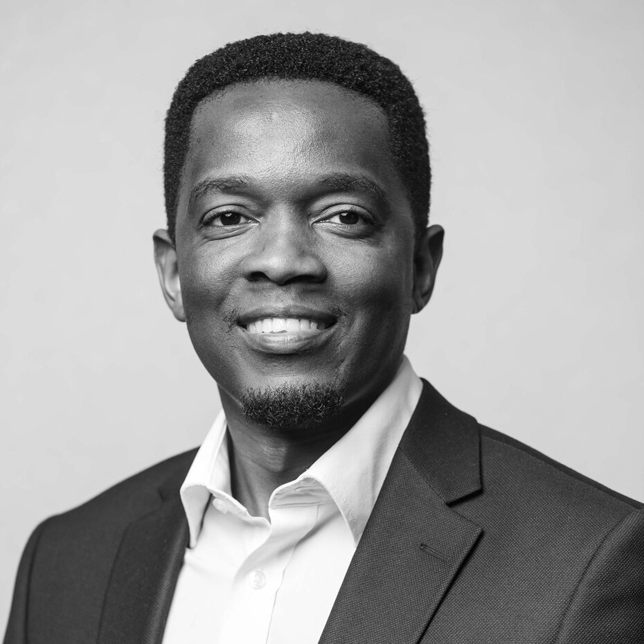 Young black man in a suit smiling